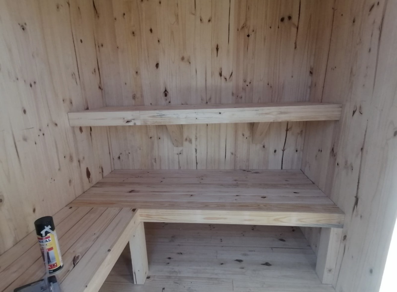 Interior of a custom pine sauna with L-shaped benches