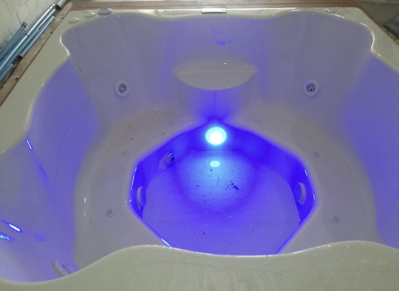 Jacuzzi interior glowing with underwater lighting